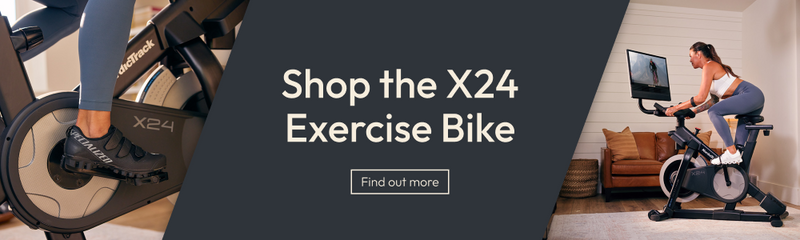 Promotional banner for the X24 Exercise Bike, featuring a close-up of a person's foot on the pedal of a black and gray bike on the left, a woman riding the bike in a living room on the right, and large white text reading 'Shop the X24 Exercise Bike' with a 'Find out more' button on a dark gray background.