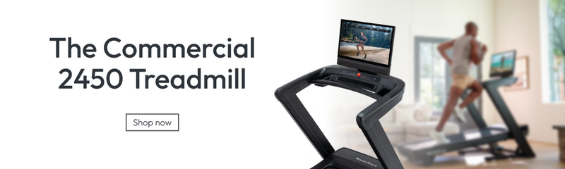 A commercial treadmill shown prominently in a bright indoor gym setting, with a blurred person running in the background and large text reading 'The Commercial 2450 Treadmill' and a 'Shop now' button.